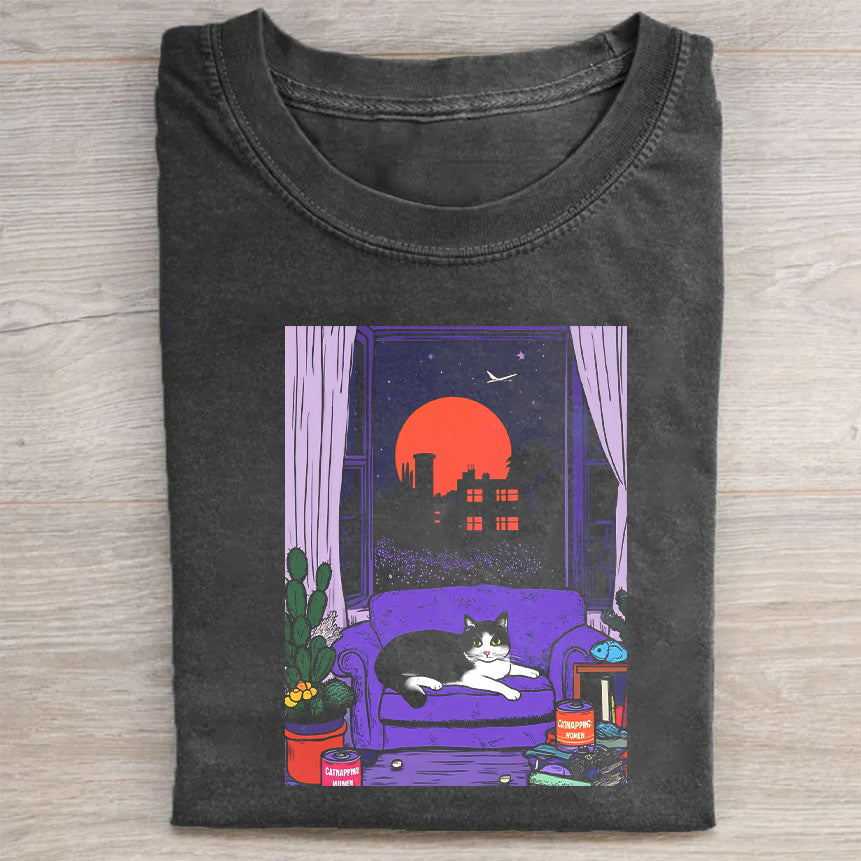 Short Sleeve Black T-Shirt with Cozy Cat on Purple Couch Print for Casual Wear